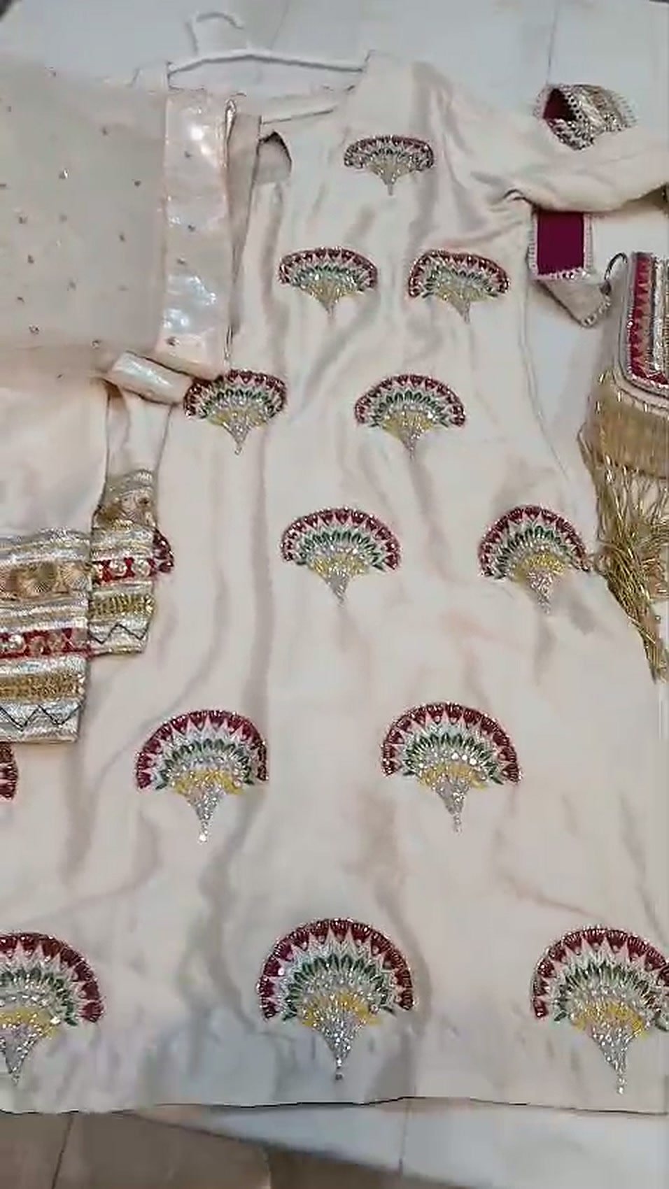 Fan motifs hand-embroidered in resham and zari on an ivory shirt, made in our workshop