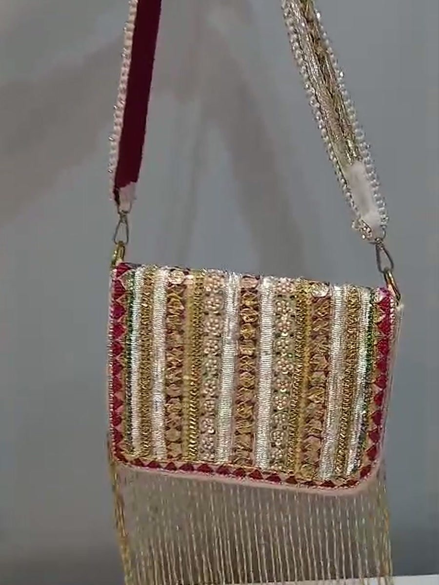 Matching clutch in gota and zari stripes with a gold fringe