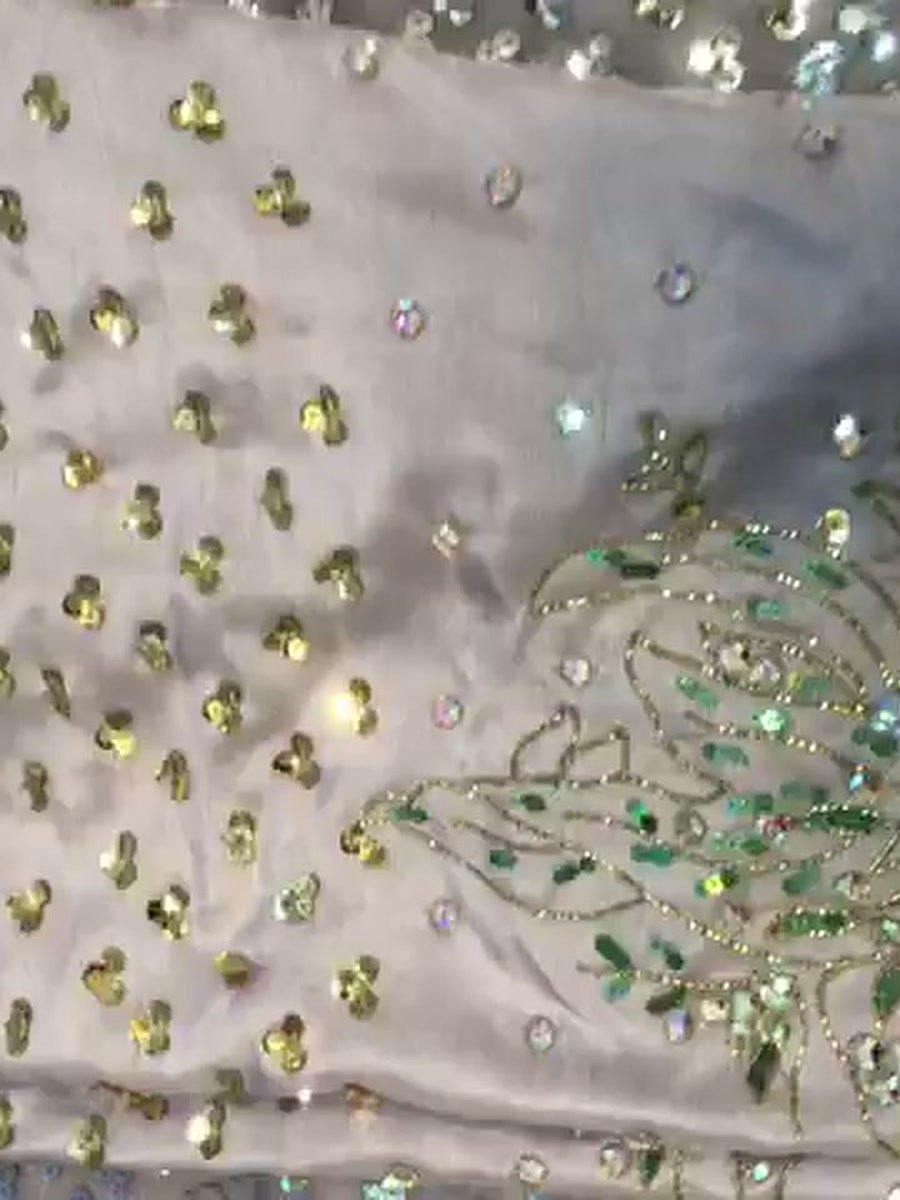 Close-up of the crystals and green bead flowers on the lilac shirt