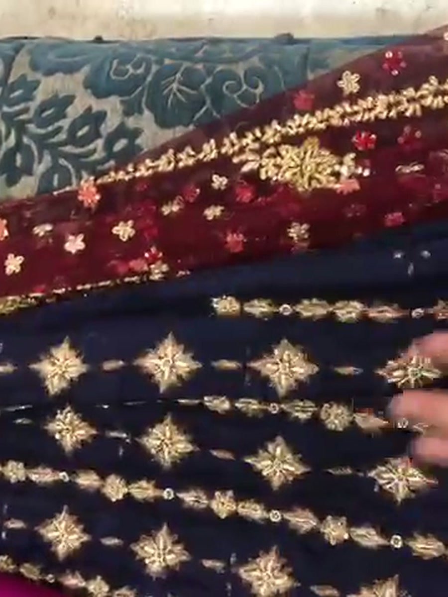 Navy velvet with gold star motifs beside maroon velvet